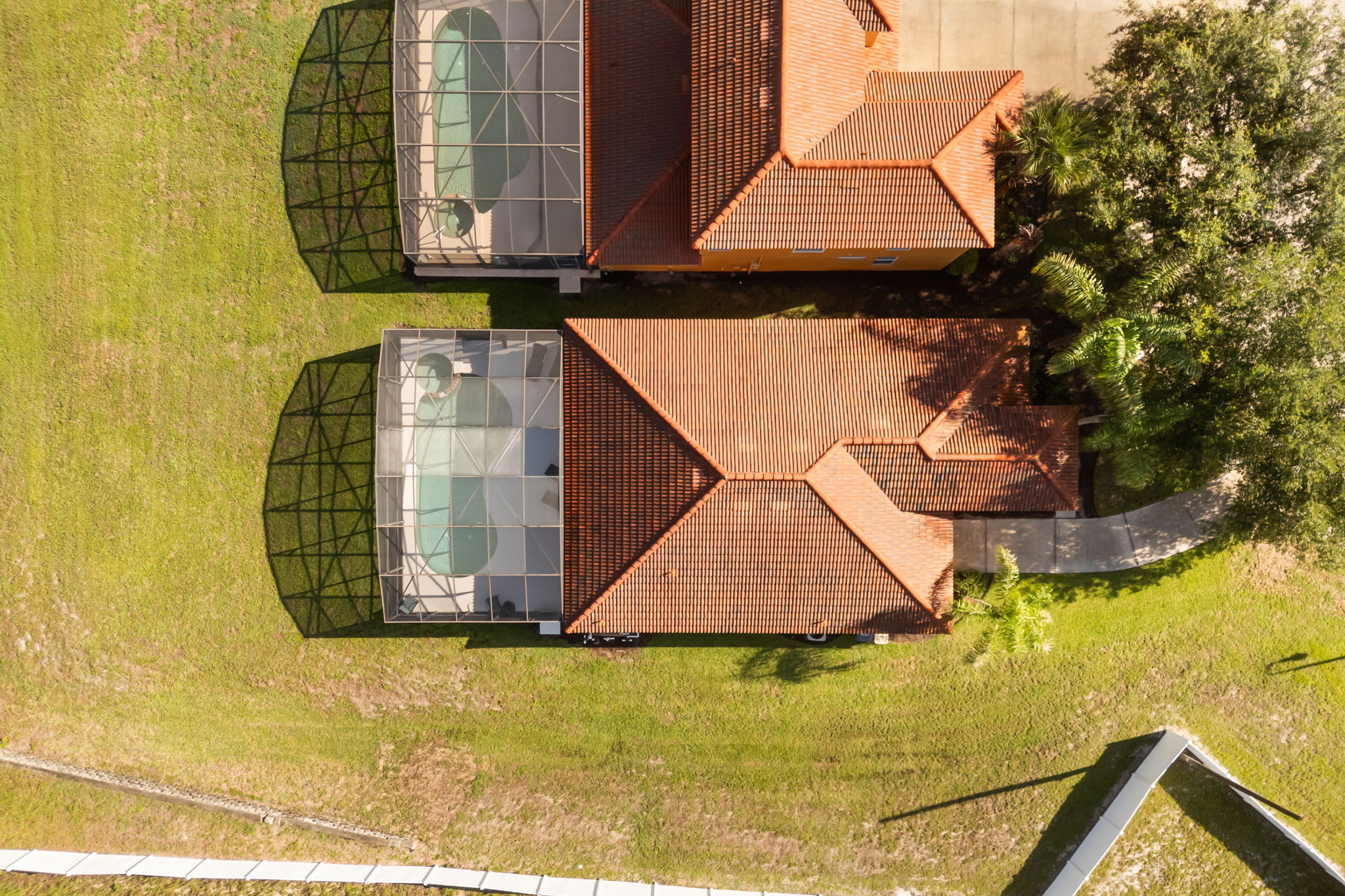 Top-down aerial view of the home and pool enclosure